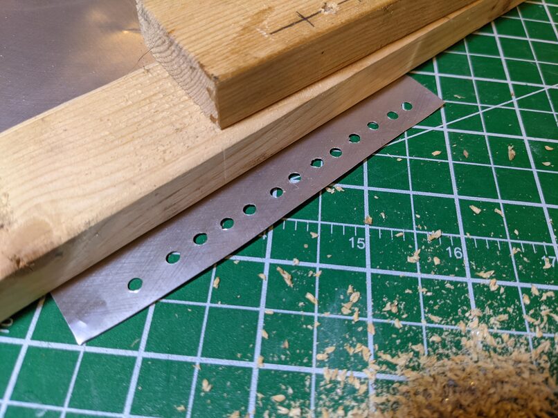 Row of holes in aluminum foil.